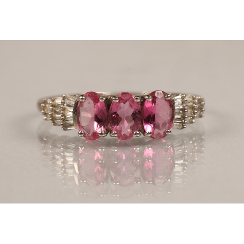 76 - 9ct white gold band set with a trio of pink gems and diamond chip shoulders