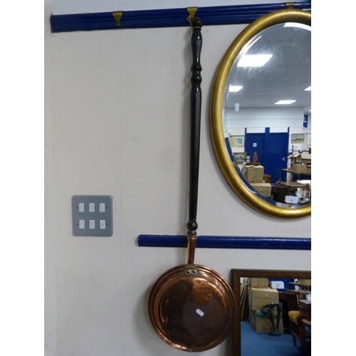 44 - Copper bed warming pan and an oval gilt mirror.  (2)