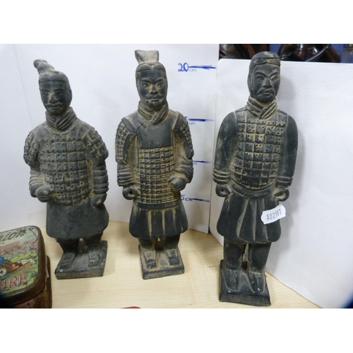 6 - Three Oriental terracotta warriors, Sandilands Whisky decanter, a tin decorated with the landing of ... 