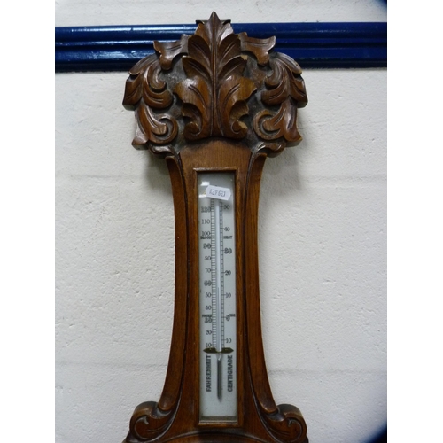 64 - Carved oak aneroid barometer.