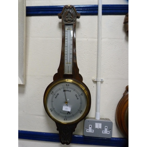 65 - Carved oak barometer.