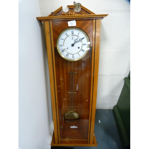 88 - Reproduction twin train wall clock with subsidiary seconds dial, with two brass-coated weights.