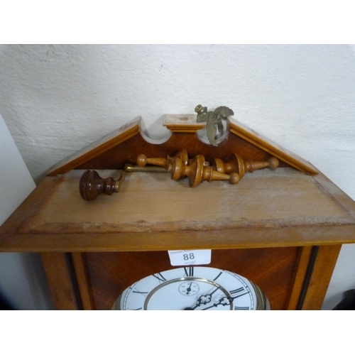 88 - Reproduction twin train wall clock with subsidiary seconds dial, with two brass-coated weights.