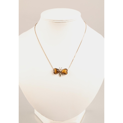 56 - 9ct gold mounted tiger's eye butterfly pendant on 9ct gold chain, total weight - 7.5g