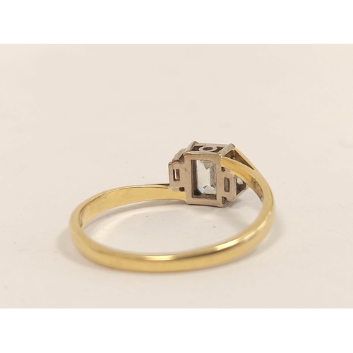 89 - 18ct gold three-stone diamond lady's baguette ring, c. 1991, set with a large baguette flanked by sm... 