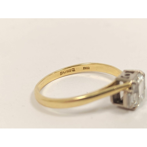 89 - 18ct gold three-stone diamond lady's baguette ring, c. 1991, set with a large baguette flanked by sm... 