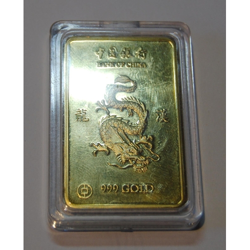 153 - Bank of China 999 gold ingot with raised five claw dragon to the obverse flanked by character marks,... 