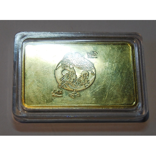 153 - Bank of China 999 gold ingot with raised five claw dragon to the obverse flanked by character marks,... 