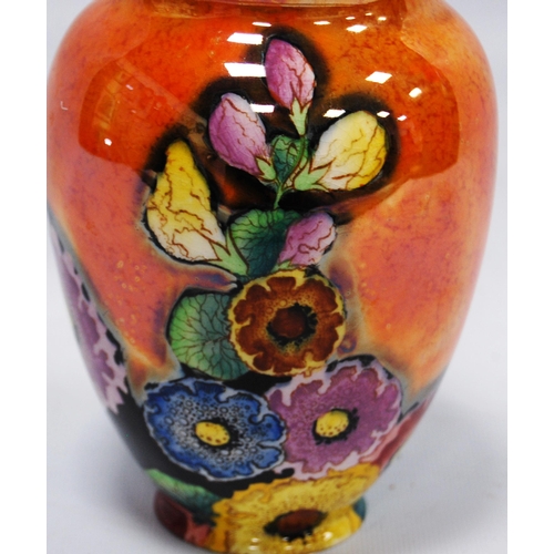 212 - Carlton Ware 'Hollyhocks' pattern lustre vase in colourful underglaze on an orange ground, 15cm high... 