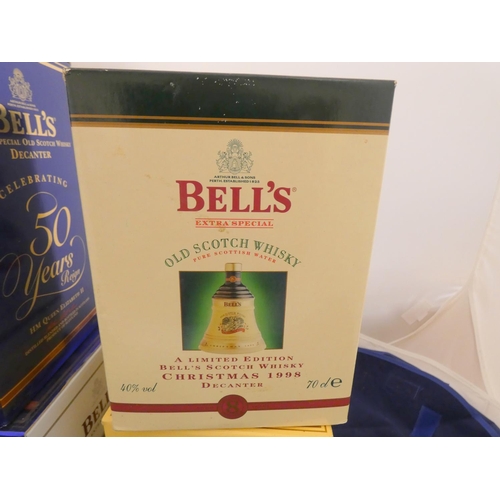 38 - Three Bell's old scotch whisky Christmas limited edition decanters with contents, Dated 1998, 2004, ... 