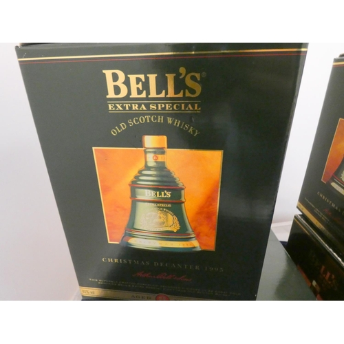 40 - Four Bell's finest old scotch whisky Christmas decanters with contents, Dated 1992, 1994, 1995, all ... 