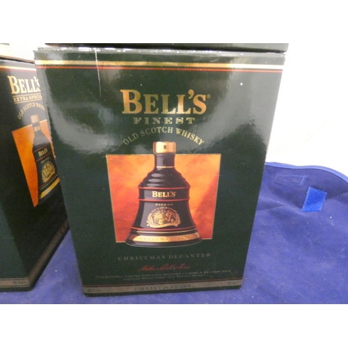 40 - Four Bell's finest old scotch whisky Christmas decanters with contents, Dated 1992, 1994, 1995, all ... 