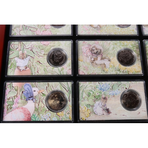 608 - The Danbury Mint The World of Beatrix Potter fifty pence collection comprising fourteen 50p coins, e... 