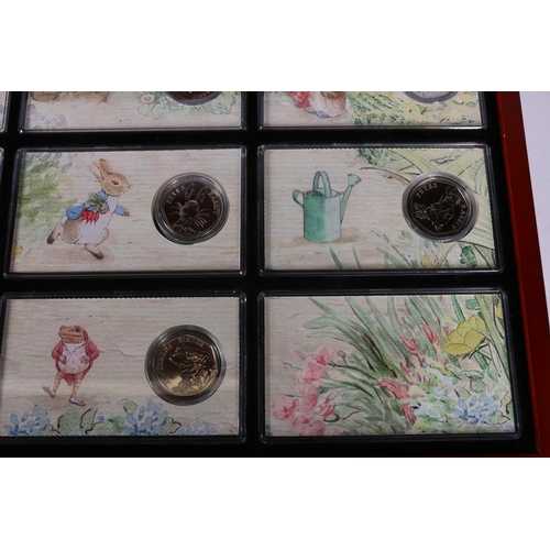 608 - The Danbury Mint The World of Beatrix Potter fifty pence collection comprising fourteen 50p coins, e... 