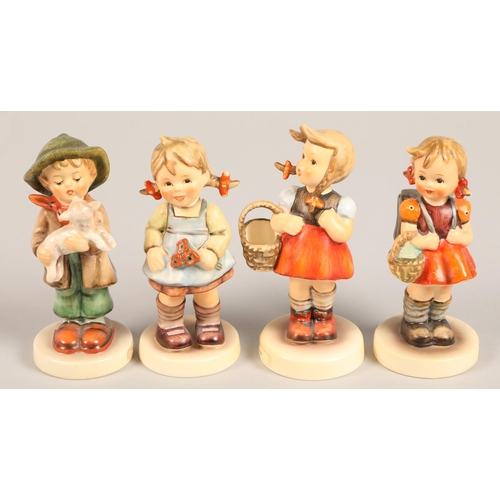 26 - Four Goebel Hummel figures, including 'School girl', 'The lost sheep' 'Little shopper' Flower girl (... 