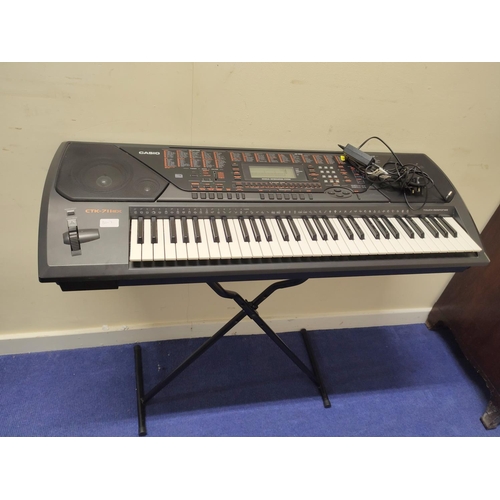 Casio CTK-711 electric keyboard with stand.