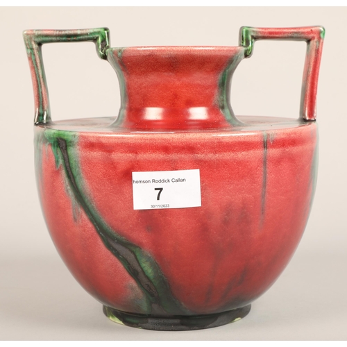 168 - Twin handled red glazed vase, impressed mark M H on base, 19 cm high