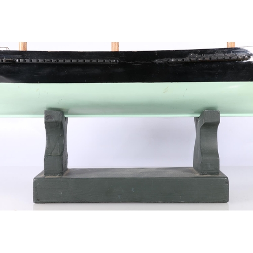 223 - Model ship hull 'Ariel' raided on wooden plinth, 58cm long.