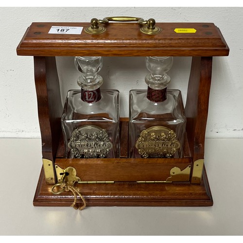 187 - Hardwood double tantalus with two Whyte & Mackay whisky bottles.