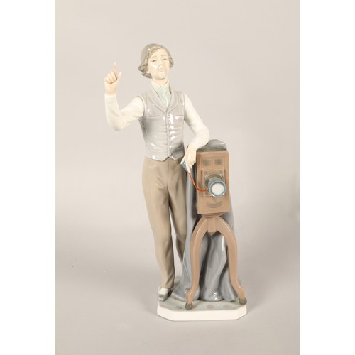 143 - Lladro figure, gentleman with vintage camera projector.