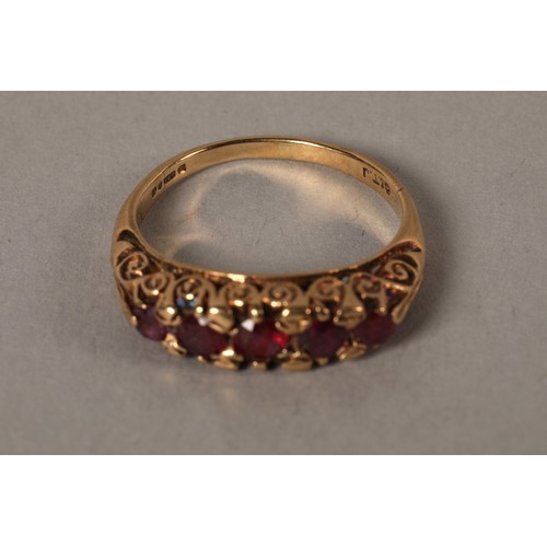 58 - 9ct yellow gold ring set with five garnets stones, size O