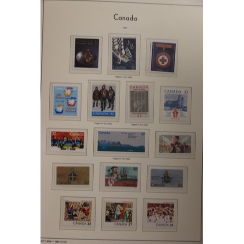 521 - Stamp collection held across six albums to include two leatherette albums in slip cases Canadian min... 