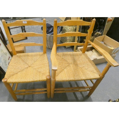 462 - Two rush seat modern ladder back chairs.