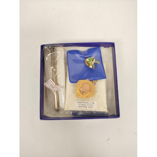 113 - Box containing Rugby pin badges, a silver propelling pencil and a 9ct gold fob medal dated 1951. 3.8... 