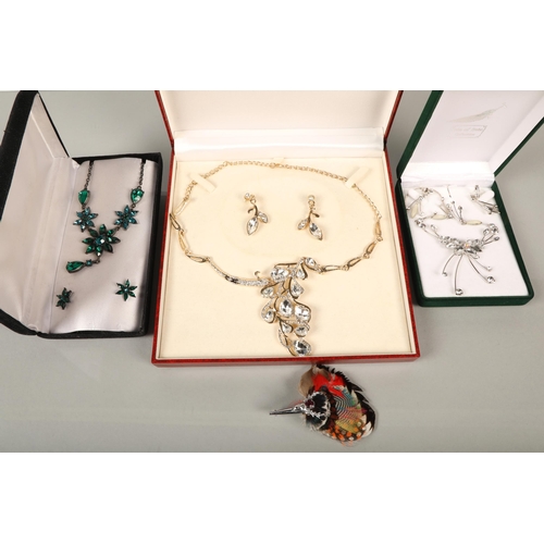 137 - Boxed costume jewellery including feathered stag brooch, 