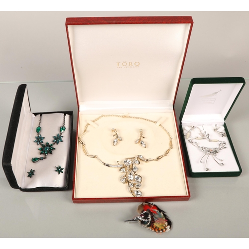 137 - Boxed costume jewellery including feathered stag brooch, 