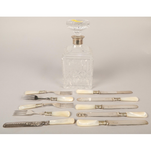 148 - Silver collared crystal decanter, mother of pearl knives and forks