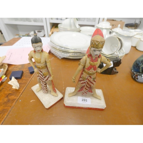 285 - Two treen carved Indian figures. 21cm high.