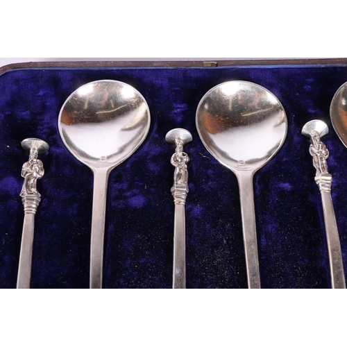 52 - Two cased sets of six white metal serving spoons with apostle terminals.