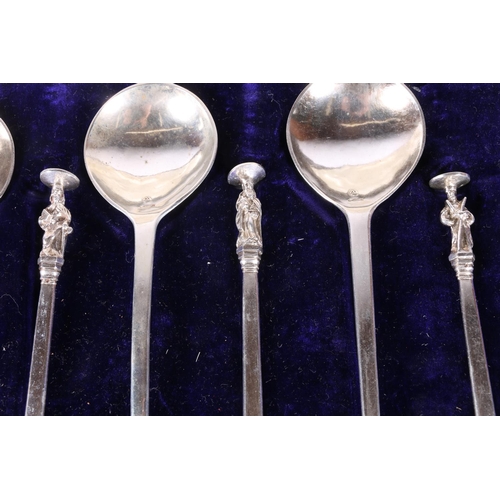 52 - Two cased sets of six white metal serving spoons with apostle terminals.