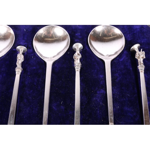 52 - Two cased sets of six white metal serving spoons with apostle terminals.