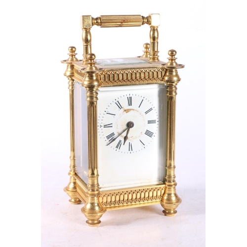 58 - French gilded brass carriage clock, the white enamel dial with Roman numerals, 16cm tall.