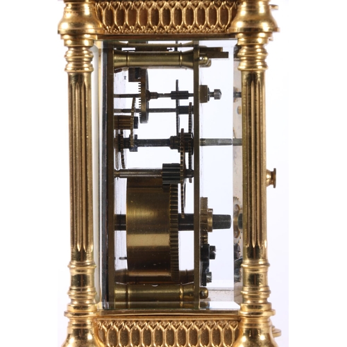 58 - French gilded brass carriage clock, the white enamel dial with Roman numerals, 16cm tall.