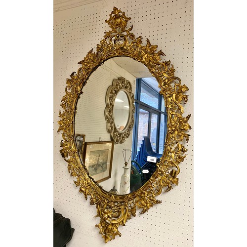 400 - Large oval gilt metal framed mirror, 105 x 68 cm