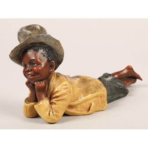 315 - Figure of boy lying down with hat