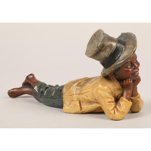 315 - Figure of boy lying down with hat