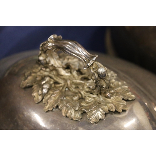 106 - Two large silver-plated cloches with ornate oak leaf and acorn handles, 48cm x 38cm, 28cm high inclu... 