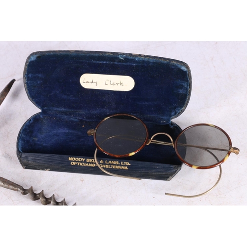 107 - Unmarked steel corkscrew and a pair of tortoiseshell rimmed spectacles.  (2)