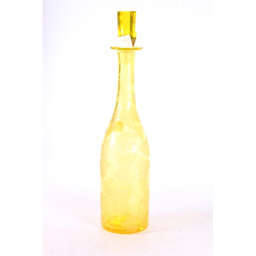 115 - Bohemian yellow glass wine decanter decorated with etched design fruiting grapevine, 35cm high to to... 