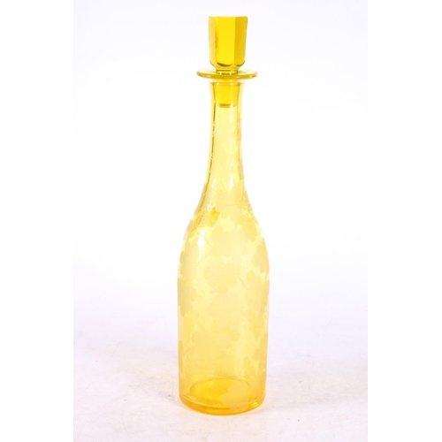 115 - Bohemian yellow glass wine decanter decorated with etched design fruiting grapevine, 35cm high to to... 