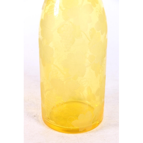 115 - Bohemian yellow glass wine decanter decorated with etched design fruiting grapevine, 35cm high to to... 