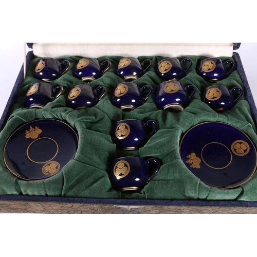 123 - Japanese Satsuma coffee set with Bristol Blue ground and gilt floral decoration in fitted case.