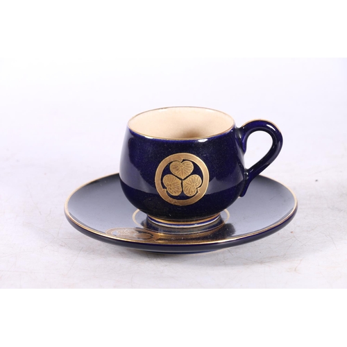 123 - Japanese Satsuma coffee set with Bristol Blue ground and gilt floral decoration in fitted case.