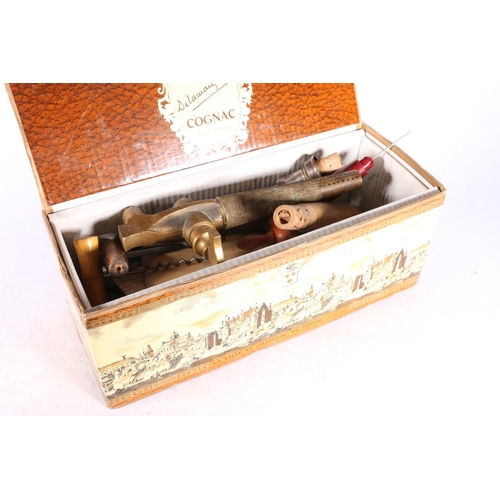 310 - Box containing a antique brass water sprinkler, two wooden cask barrel taps, corkscrews, etc.