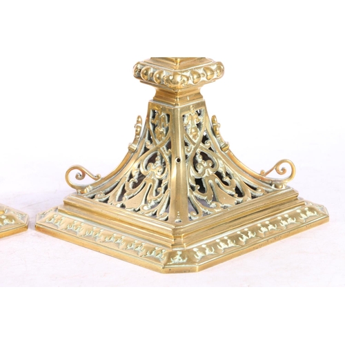 67 - Pair of pierced brass candlesticks with circular galleries platform drip trays raised on square base... 