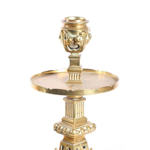 67 - Pair of pierced brass candlesticks with circular galleries platform drip trays raised on square base... 